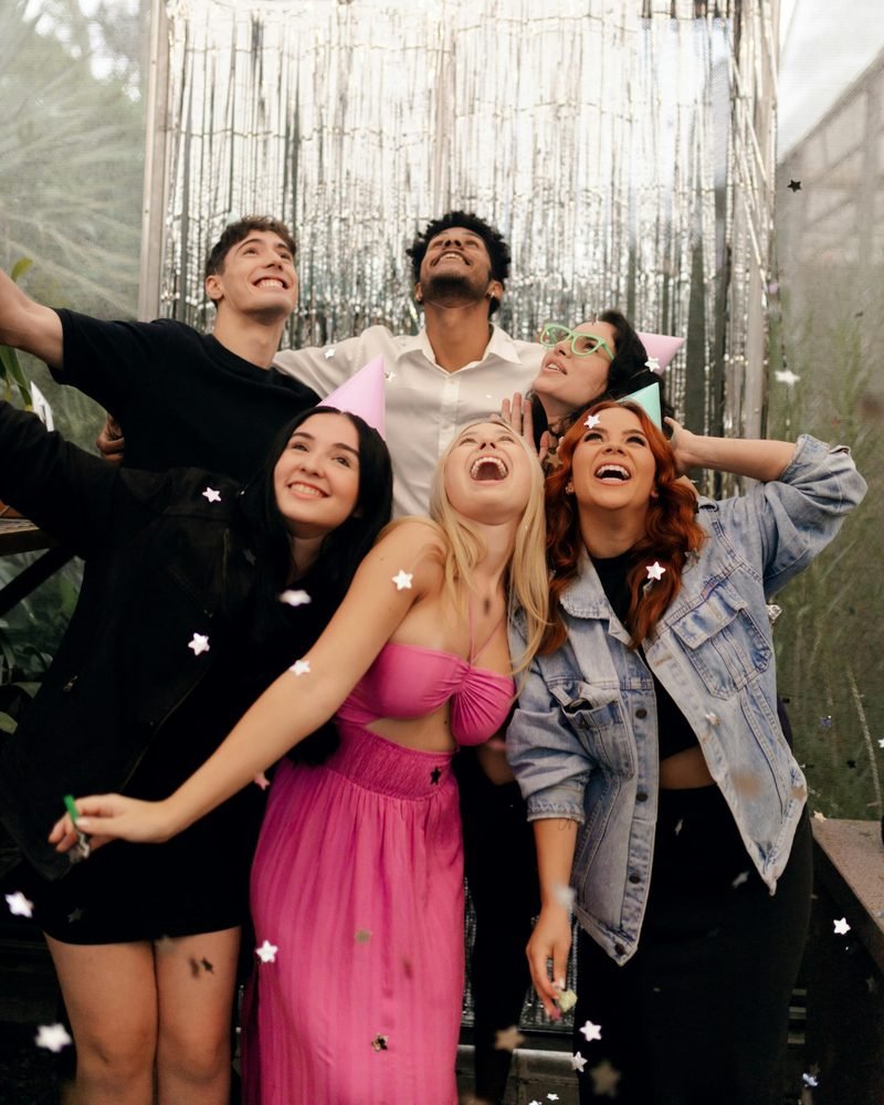 Friends celebrating under falling confetti