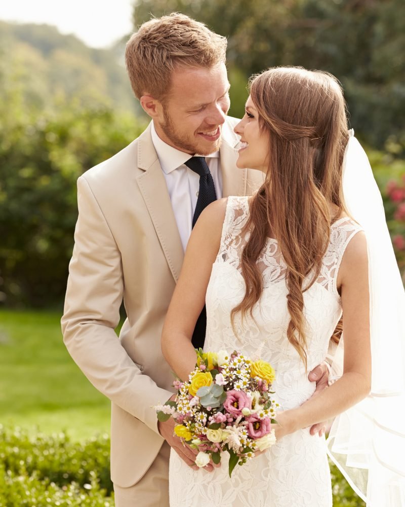A couple laughing together in a garden